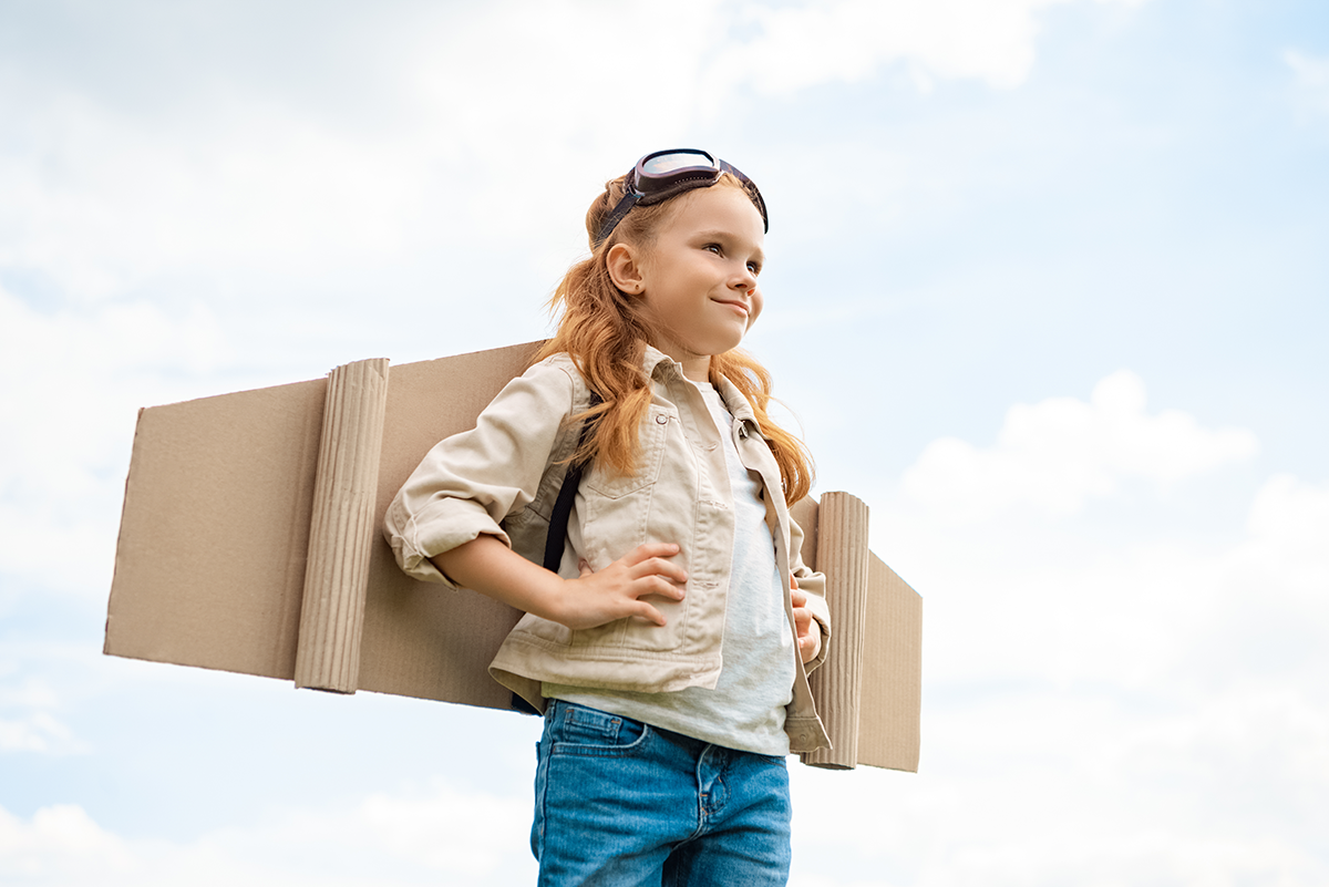 low-angle-view-of-child-with-paper-plane-wings-on-2023-11-27-05-03-40-utc